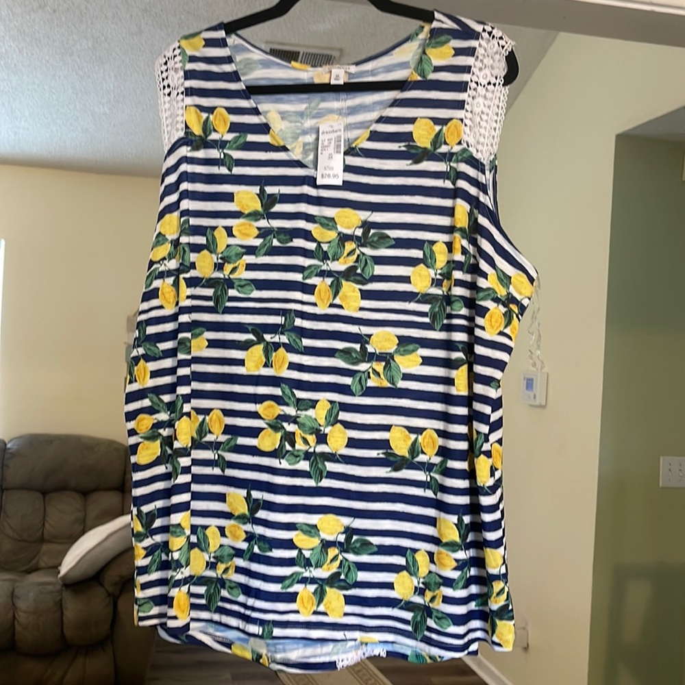 Very nice new with tags shirt lace cap sleeve and lace strips down the back.